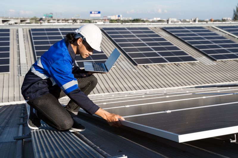 Technicians inspecting solar panels